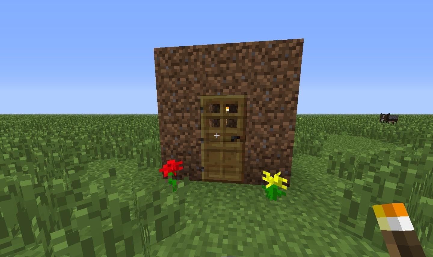 a small dirt house that was built in Minecraft. there is grass and flowers around the house.